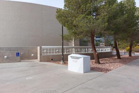 Large white library drop box located near the southest corner of the Classroom Building Complex - Building A.