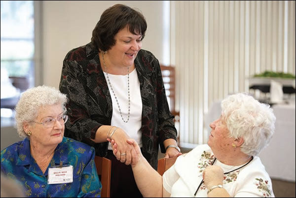 Patricia Iannuzzi, University Libraries dean, greets honorees Billie Mae Polson and Carolyn Rogers
