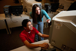 Two peer coaches Using the Microfiche machine